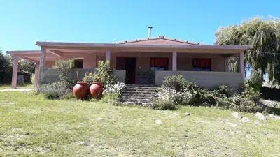 a house with two large vases in front of it at Cabañas San Gerónimo in San Jerónimo