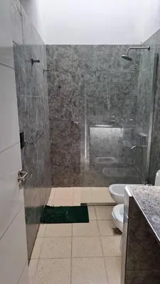 a bathroom with a shower with a toilet and a sink at Bosquesito in Mina Clavero