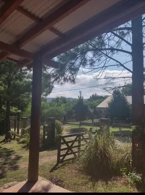 a view from the porch of a barn with a picnic table at Mainumby in Santa Rosa de Calamuchita