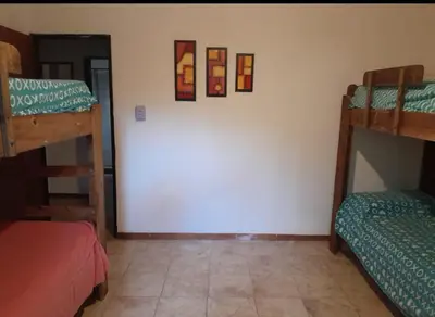 a room with three bunk beds in a room at Mainumby in Santa Rosa de Calamuchita
