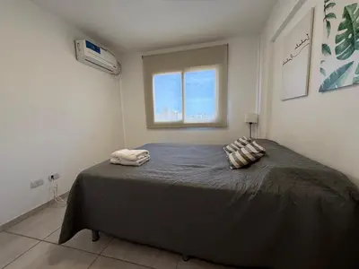a bedroom with a bed with two pillows on it at DEPTO B GENERAL PAZ Cerca de Clínica Reina Fabiola in Cordoba