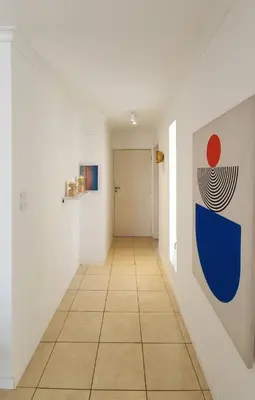 a hallway with white walls and a tile floor at Moderno PENTHOUSE en Nueva in Cordoba