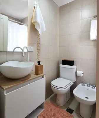 a bathroom with a white sink and a toilet at Moderno PENTHOUSE en Nueva in Cordoba