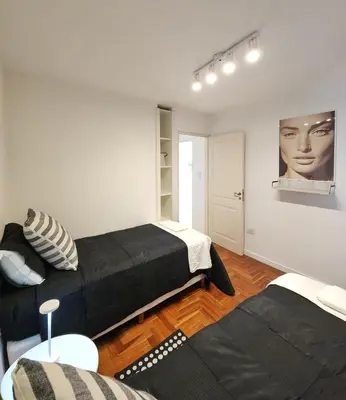 a living room with two beds and a couch at Moderno PENTHOUSE en Nueva in Cordoba