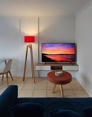a living room with a flat screen tv on a table at Moderno PENTHOUSE en Nueva in Cordoba