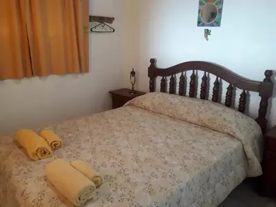 a bedroom with a bed with two towels on it at Cabañas San Gerónimo in San Jerónimo
