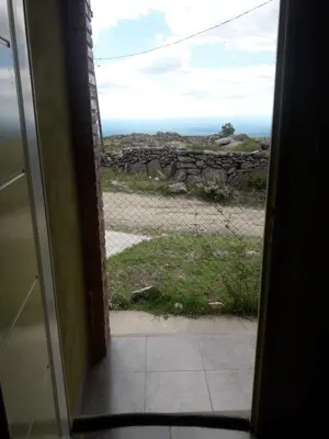 a door to a room with a view of the ocean at Cabañas San Gerónimo in San Jerónimo