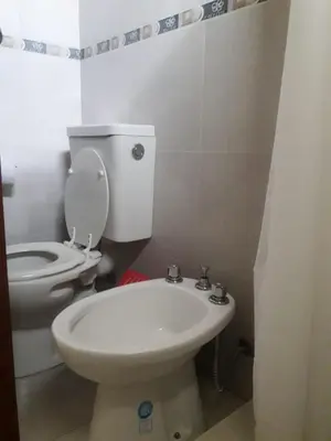 a bathroom with a white toilet and a sink at Cabañas San Gerónimo in San Jerónimo