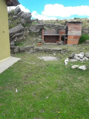 an old brick building in a field of grass at Cabañas San Gerónimo in San Jerónimo