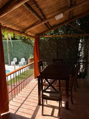 a patio with a table and chairs on a deck at Verano Paz in Villa Carlos Paz