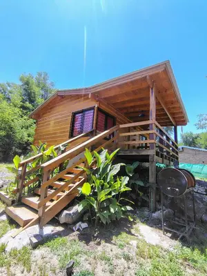 a log cabin with a staircase leading up to it at Cabaña Aurora in Santa Rosa de Calamuchita