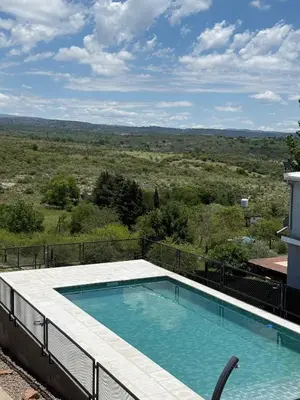 a swimming pool on top of a building with a view at Cabañas La Caprichosa in Villa Santa Cruz del Lago