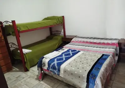 a bedroom with a bed and a bunk bed at Capfer in Alta Gracia