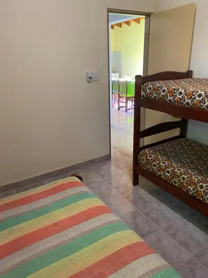 a room with two bunk beds and a rug at Las Luciernagas de Nono in Nono