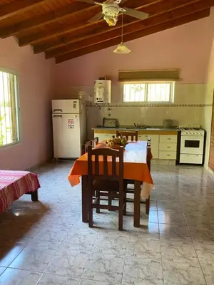 a kitchen with a table and chairs in a room at Las Luciernagas de Nono in Nono