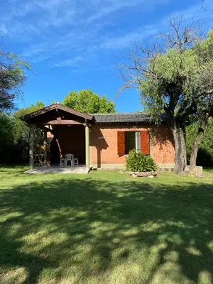 a house with a large yard with a tree at Las Luciernagas de Nono in Nono