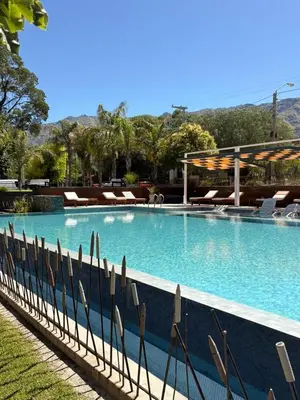 a large swimming pool with chairs in a resort at Altos De Merlo Suites in Merlo