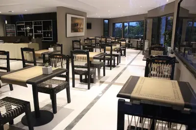 a restaurant with tables and chairs in a room at Altos De Merlo Suites in Merlo