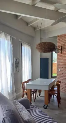 a dining room with a white table and chairs at La casa de Merlot in San Antonio de Arredondo