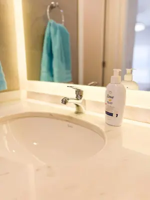 a bathroom sink with a soap bottle next to a mirror at Relax y diseño frente a la Ciudad Universitaria in Cordoba