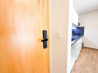 a wooden door in a kitchen with a counter at Relax y diseño frente a la Ciudad Universitaria in Cordoba