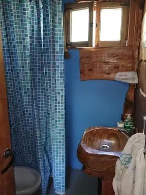 a bathroom with a wooden sink and a window at Cabaña El Poeta in Cuesta Blanca