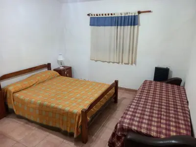 a bedroom with two beds and a window at Casa Doña Victoria in Villa Carlos Paz
