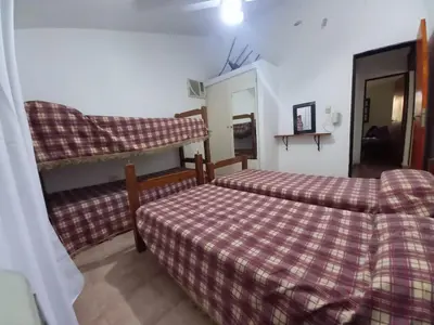 a bedroom with two beds and a mirror at Casa Doña Victoria in Villa Carlos Paz