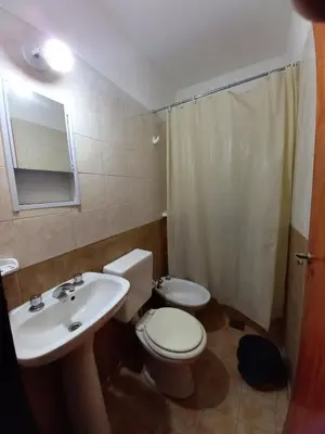 a bathroom with a toilet and a sink and a shower at Casa Doña Victoria in Villa Carlos Paz