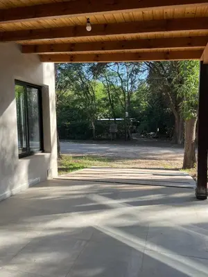 an empty patio with a wooden roof over a building at Wanna Hospedaje in Villa Ciudad Parque