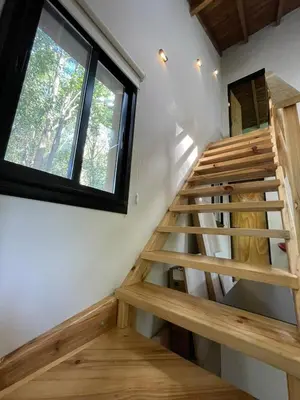 a staircase in a tiny house with a window at Wanna Hospedaje in Villa Ciudad Parque