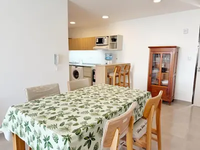 a kitchen and dining room with a table and chairs at Edifico NAMBA in Villa Carlos Paz