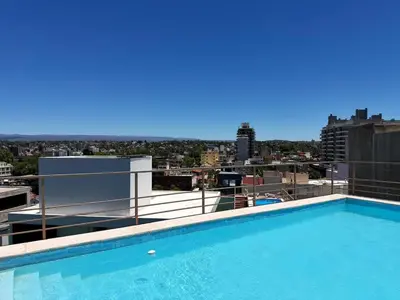 a swimming pool on the roof of a building at Edifico NAMBA in Villa Carlos Paz