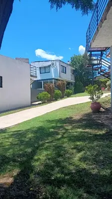 a house with a staircase in a yard at complejo Los Ceibos 2 in Villa Carlos Paz
