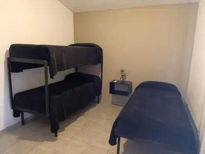 a room with two bunk beds and a tv at complejo Los Ceibos 2 in Villa Carlos Paz