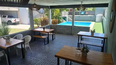 a patio with tables and a swimming pool at complejo Los Ceibos 2 in Villa Carlos Paz