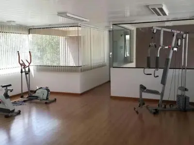 a gym with two exercise bikes and a mirror at Moderno Depto 2 dormitorios frente al lago Pileta asador garage in Villa Carlos Paz