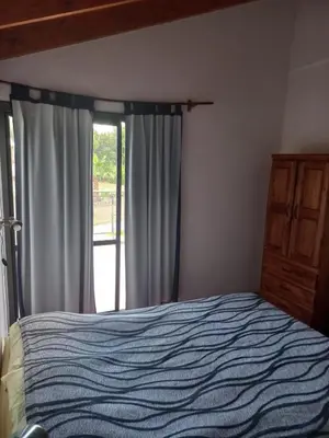 a bedroom with a bed and a window at Lo de la Abu in Villa de Las Rosas