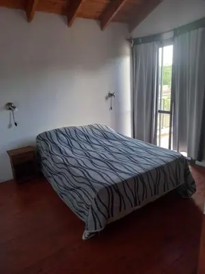 a bedroom with a bed and a window in a room at Lo de la Abu in Villa de Las Rosas