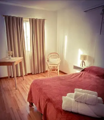 a bedroom with a bed and a chair and a table at Lamorit in Almafuerte