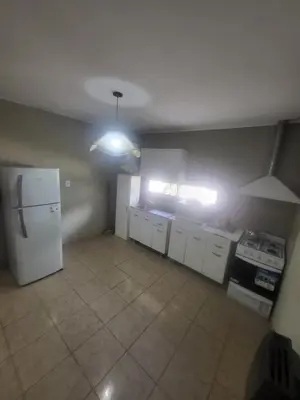 an empty kitchen with a white refrigerator and cabinets at Lamorit in Almafuerte