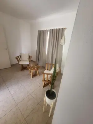 a living room with a chair and a potted plant at Lamorit in Almafuerte