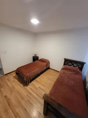 a room with two beds and a wooden floor at Lamorit in Almafuerte