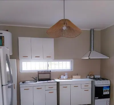 a kitchen with white cabinets and a white refrigerator at Lamorit in Almafuerte
