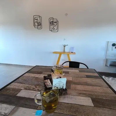 a wooden table with two glasses on top of it at Moderno Departamento para parejas Merlo S Luis centro Vistas in Merlo