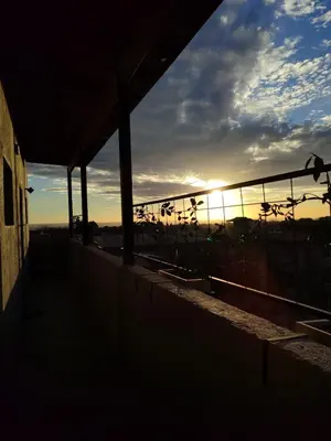 a sunset from a building with the sun setting in the sky at Moderno Departamento para parejas Merlo S Luis centro Vistas in Merlo