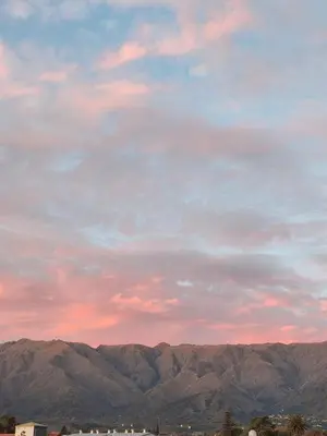 a cloudy sky with mountains in the background at Moderno Departamento para parejas Merlo S Luis centro Vistas in Merlo
