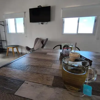a wooden table with a drink on top of it at Moderno Departamento para parejas Merlo S Luis centro Vistas in Merlo