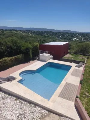 a swimming pool in front of a building at Lucerito no reserve x aca in Villa Santa Cruz del Lago