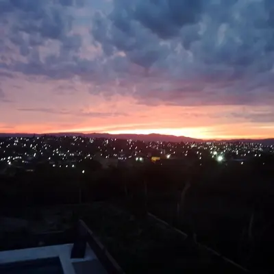 a view of a city at sunset at Lucerito no reserve x aca in Villa Santa Cruz del Lago
